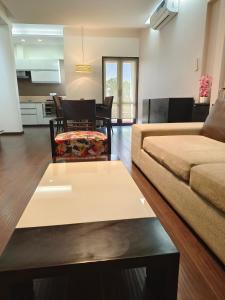 a living room with a couch and a table at BLOSSOM Studio in Manesar