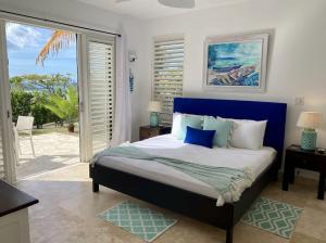 a bedroom with a large bed with a blue headboard at Lookout in Bolans