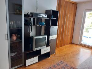 a black entertainment center with a tv and a tvictericterictericterictericter at Luxury Apartment in Ulcinj
