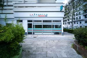 a building with a sign on the front of it at La Regence in Courbevoie