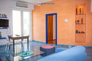 a living room with a couch and a table at Al Curvone 2 in Lido di Ostia +5 photos