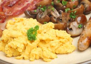 a plate of food with scrambled eggs and mushrooms at Station House Hotel Letterkenny in Letterkenny