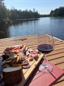 a table with a plate of food and a glass of wine at La Félicita chalet in Saint Adolphe D'Howard