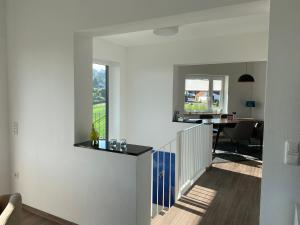 a living room with a staircase and a dining room at Ferienhaus Eckeweg 1 in Waldeck