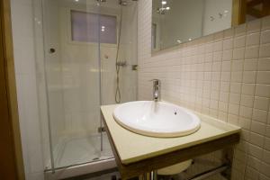 a bathroom with a sink and a shower at Apartamentos Turísticos Pacios in Santiago de Compostela