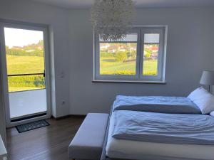 a bedroom with a bed and two windows at Ferienhaus Eckeweg 1 in Waldeck