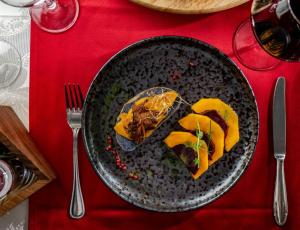a plate of food sitting on a red table at Hotel Cvita in Split