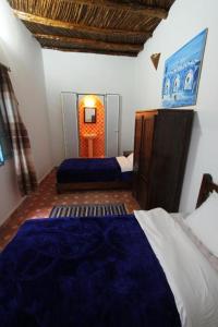 Postel nebo postele na pokoji v ubytování Dar Tranquille