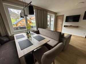 sala de estar con mesa de comedor y sofá en Appartement Ski-Willy, en Ramsau am Dachstein