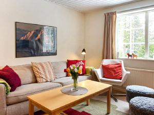 a living room with a couch and a table at 4 person holiday home in S LEN in Sälen