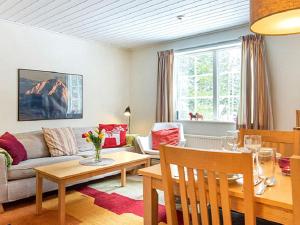 a living room with a couch and a table at 4 person holiday home in S LEN in Sälen