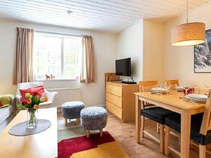 a living room with a table and a dining room at 4 person holiday home in S LEN in Sälen