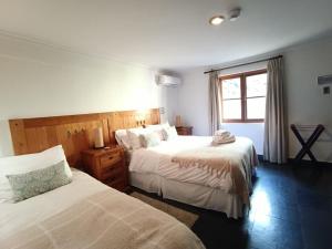 Un pat sau paturi într-o cameră la Casa Arrayán