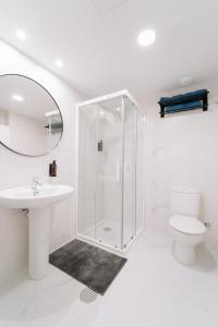 a white bathroom with a shower and a toilet at San Bernardo, 19 in Avilés