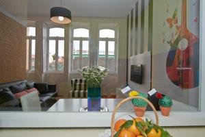 a living room with a table with fruit on it at Bolhão Nobre Apartments in Porto