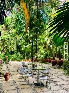 a patio with a table and chairs and plants at La Cour Hotels and Apartments Cooper in Lagos
