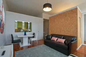 a living room with a couch and a coffee table at Bolhão Nobre Apartments in Porto