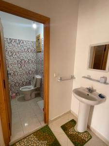 a bathroom with a sink and a toilet at Economic Apartment Alhoceima WIFI in Al Hoceïma