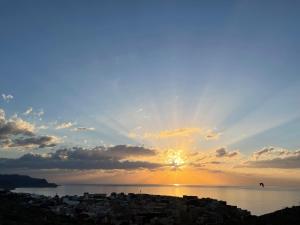 a view of the sun setting over the water at Economic Apartment Alhoceima WIFI in Al Hoceïma
