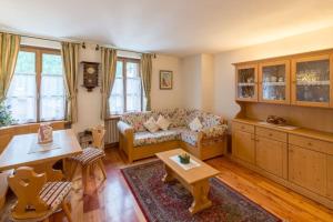 - un salon avec un canapé et une table dans l'établissement Cozy apartment near Cortina, à San Vito di Cadore