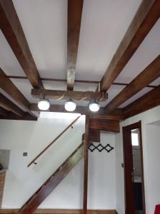 a ceiling fan in a room with wooden beams at Ayas Apart in Macka
