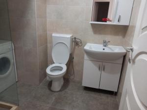 a bathroom with a toilet and a sink at Luxury Apartment in Ulcinj
