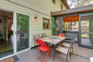 a patio with a table and chairs on a house at Private Hot Tub and Fire Pit Pocono Lake House! in Pocono Lake
