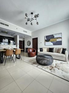 a living room with a couch and a table at Nasma Luxury Stays - Botanica Tower in Dubai