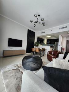 a living room with a couch and a table at Nasma Luxury Stays - Botanica Tower in Dubai