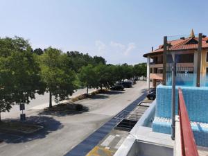 arial view of a pool at a hotel with a parking lot at Casa Giulia in Grado
