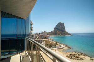 a view of the beach from the balcony of a building at Apartamentos Vista Bella in Calpe