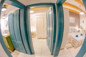 a hallway with blue doors and a bedroom at Vila Vintage in Šajdíkove Humence