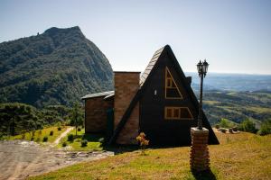 a small house sitting on top of a hill at Caminho das Nuvens - Cabanas de Montanha in Bom Retiro