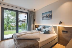 Posteľ alebo postele v izbe v ubytovaní Thalhof Apartments