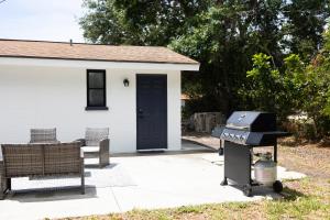 a grill in front of a house with two benches at A Travelers Nook! A Luxury ADU full of Abundance. in Venice
