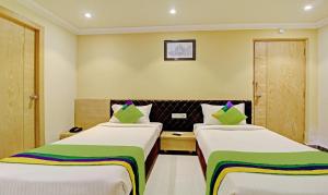 a hotel room with two beds in a room at Treebo Trend ASL Prime in Kolkata