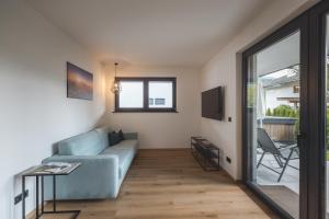 Televízia a/alebo spoločenská miestnosť v ubytovaní Thalhof Apartments