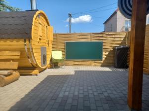 a backyard with a wooden fence and a screen at Dom z Sauną i Jacuzzi Rowery Elektryczne in Gołdap