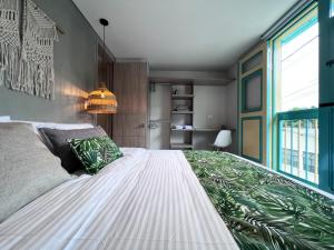 a bedroom with a large bed with a large window at Parallelo Loft Salento P2 in Salento