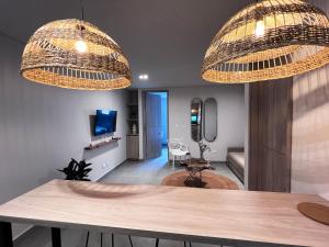 a living room with two hanging chandeliers at Parallelo Loft Salento P2 in Salento