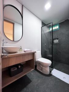 a bathroom with a sink and a toilet and a mirror at Parallelo Loft Salento P2 in Salento