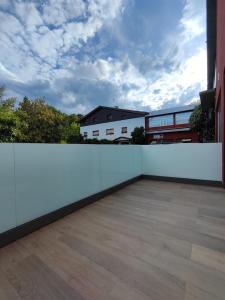 a balcony with a white fence and a building at Apartamentos Pillotegi parking gratuito in San Sebastián