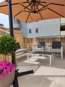 a patio with a table and chairs and an umbrella at Lovin Puglia Vacation in Bari