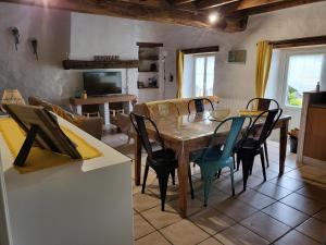 a kitchen and dining room with a table and chairs at Gite Chamarel in Les Aubiers