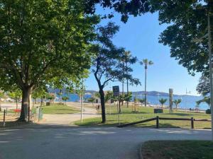 a park with trees and the ocean in the background at cosy appartement avec parking au centre et port in Toulon