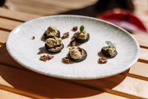 a white plate of food on a table at Chalet Sofija in Gozd Martuljek