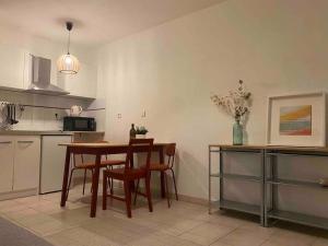 a kitchen with a table and two chairs and a table at cosy appartement avec parking au centre et port in Toulon