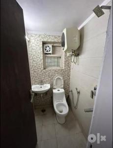 a small bathroom with a toilet and a sink at Chabbra niwas kanpur in Kānpur