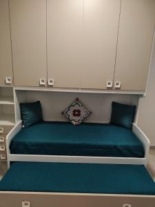 a bed with blue pillows in a room at Lovin Puglia Vacation in Bari