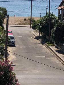 a street with two cars parked on the beach at AZALEA HOTEL in Sarti